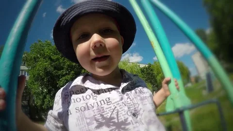 Joyful, cheerful cute child, funny baby kid boy is riding on old swing Stock Footage