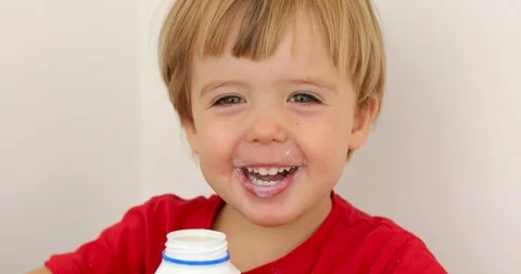 Joyful child drinking yogurt Stock Footage 109057725