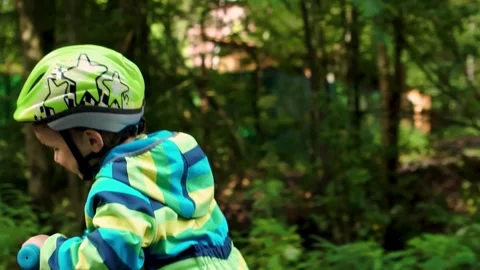 Joyful Child Learning Balance on First Bike Stock-Footage 316307633