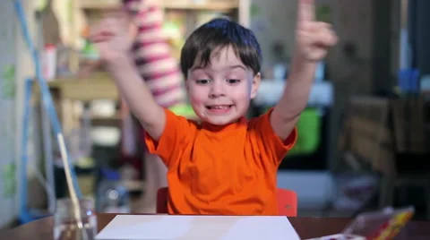 Joyful child at the table with a brush Stock Footage 60419342