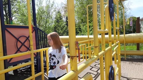 Joyful child walks through maze of yellow pipes. Stock Footage 271594997