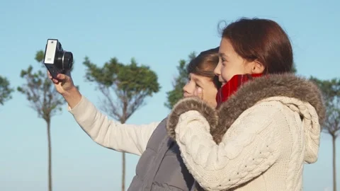 Joyful children capturing a selfie with a camera Stock Footage 311985452