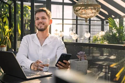 Joyful computer programmer looking at camera in cosy office Stock-Fotos
