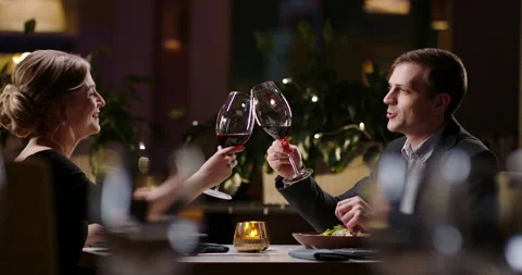 Joyful couple having a romantic dinner at a fancy restaurant. People celebrating Stock Footage 152014858