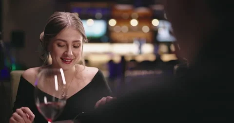 Joyful couple having a romantic dinner at a fancy restaurant. People enjoying Video stock 158409802