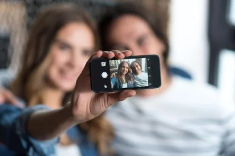 Joyful couple making selfies Stock Photos