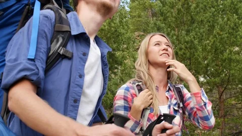 Joyful couple thinking how to climb on mountain Stock Footage 118537851
