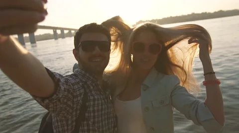 Joyful couple trying to take funny and beautiful photo of themselves 库存影片 68078978