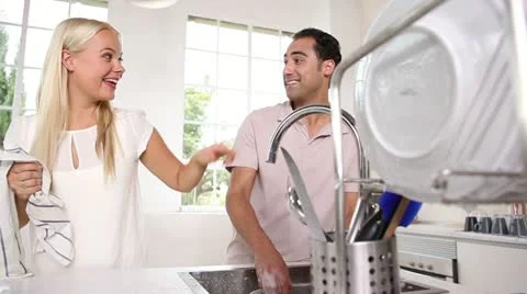 Joyful couple washing dishes together Stock Footage