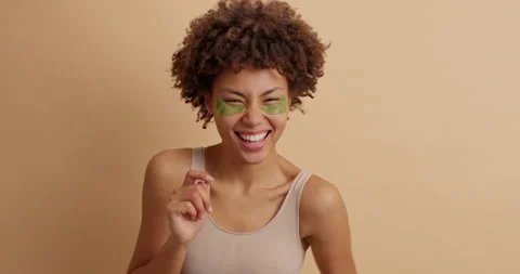 Joyful dark skinned woman points directly at camera and laughs positively Stock Footage 145348552