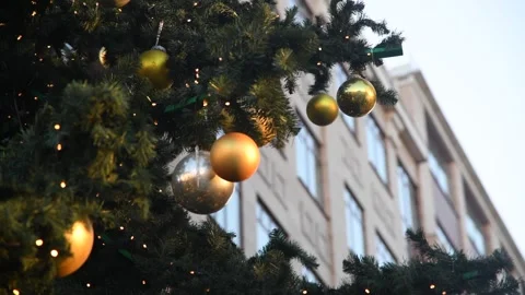 Joyful decorations adorn a festive tree in the city during holiday season Stock Footage 300085412