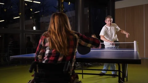Joyful disabled people playing table tennis indoor Stock Footage 125784179