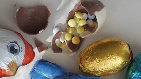 Joyful Easter Celebration with Chocolate Eggs and Colorful Wrappers Stock Footage 332943705