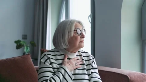 Joyful Elderly Couple Sits Lovingly on a Couch, Sh 库存影片 332684758