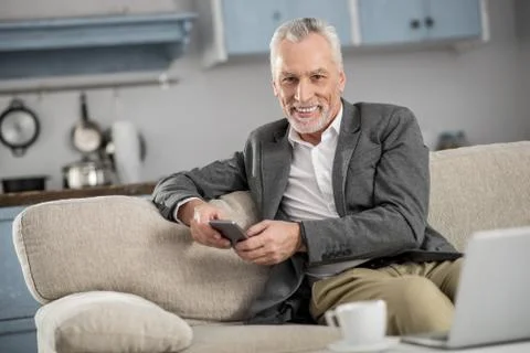 Joyful elderly man having break 스톡 사진