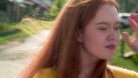 Joyful emotions on the face of a red-haired girl with freckles looking at the Stock Footage 159065715