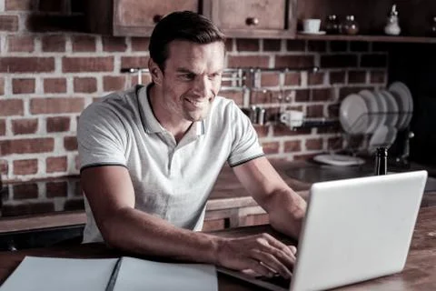 Joyful entrepreneur typing while working at home Stock Photos
