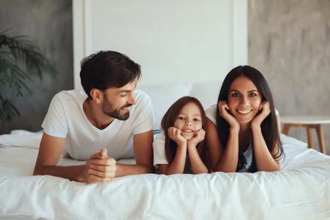 Joyful father feeling contented while resting with family Stock Photos