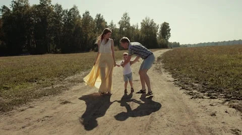 Joyful father picks his son up and rotates him Stock Footage