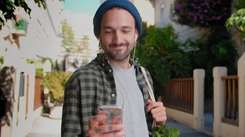 Joyful funny guy shake his head while listening favorite music online in new Stock Footage 111071255