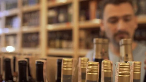 Joyful guy taking a few bottles in his hands and happily go away. Guy who Video stock 99384881