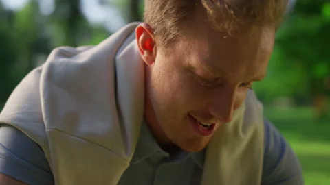 Joyful guy talking paddle in park closeu... | Stock Video | Pond5