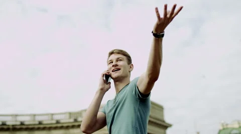 Joyful guy talking on phone Stock Footage 68857558