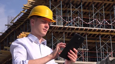 Joyful happy engineer portrait builder contractor with tablet computer 4K helmet Stock Footage 79622190