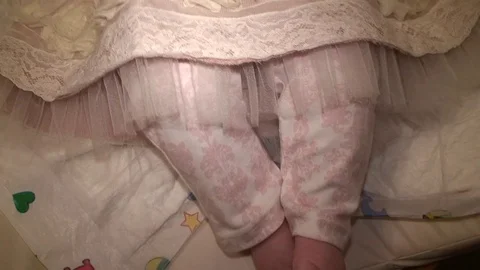 Joyful infant lying on back in festive dress and wiped mouth with a napkin Stock Footage 69826251