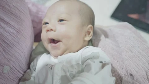 Joyful Infant Smiling in Cozy Setting Stock Footage 318629504