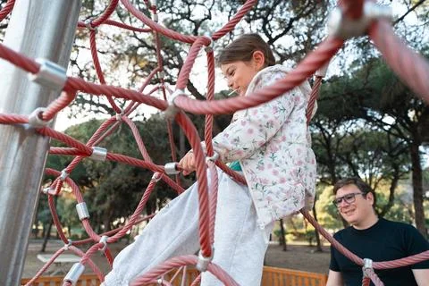 A joyful interaction between a child and an adult at a park, as the child Stock Photos