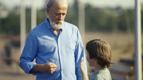 A joyful interaction between a loving grandfather and his curious grandchild in Stock Footage 312985237