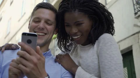 Joyful interracial couple having fun outdoors Stock Footage 132936685