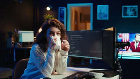 Joyful IT worker holding coffee mug and debugging code Stock Footage 283690981