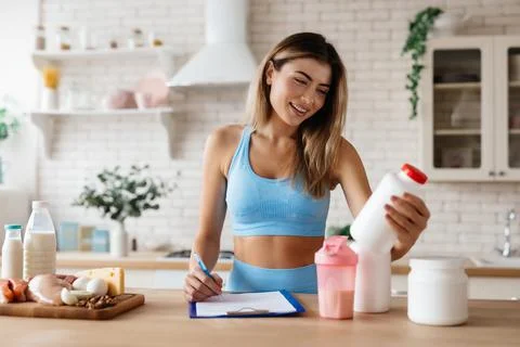 Joyful lady considering using food supplements in her daily nutrition Stock Photos