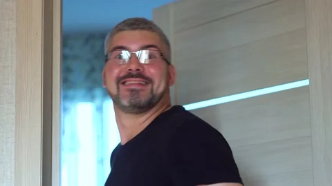 Joyful man comes inside 4K Stock Footage 205569326