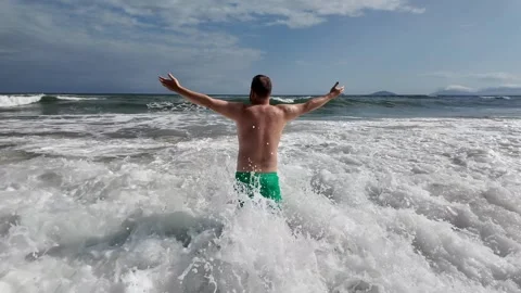 Joyful Man Embraces Ocean Waves Stock Footage 291393048