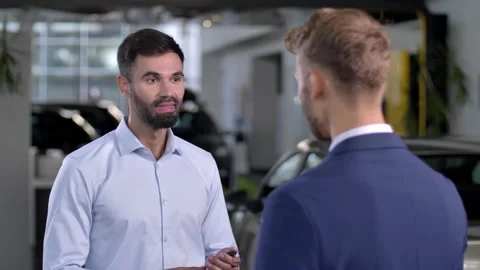Joyful man getting keys to car at auto dealership Video stock 146752440