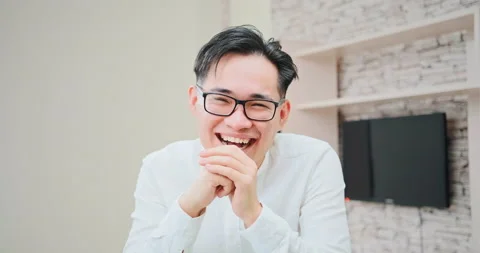 Joyful man laughs at computer talking via video call Stock Footage