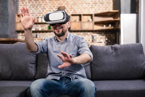 Joyful man testing VR device Stock Photos
