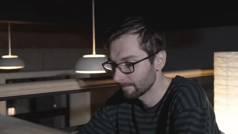 Joyful man using laptop computer at remote workplace in slow motion Stock Footage 118375071