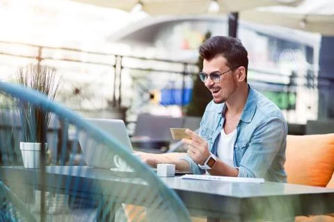 Joyful man using laptop Stock Photos