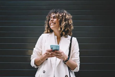 Joyful millennial blogger using cellular technology near copy space, Stock Photos