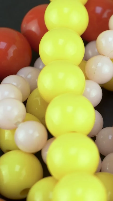 Joyful mix of vibrant beads reflects fun and retro expression Stock Footage 345605013