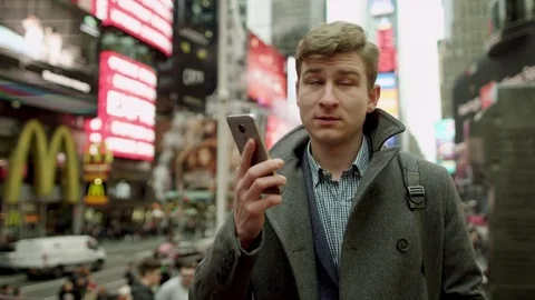 Joyful mobile phone conversation on a crowded street of New York City Stock-Footage 79586190