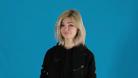 Joyful model smiles at camera spreading arms out to sides Video stock 306503108