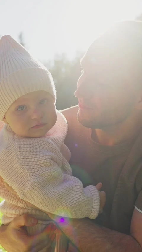 Joyful moment between parent and baby in nature during sunny afternoon Stock Footage 308936703