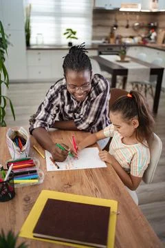 Joyful moments of creativity shared between a child and caregiver Stock Photos
