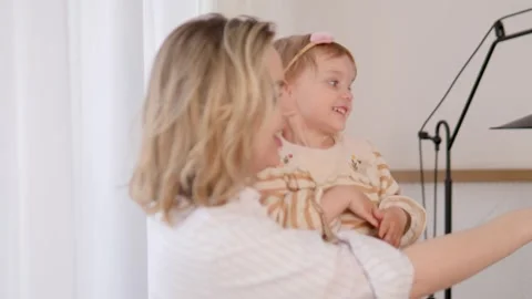 Joyful moments shared between a loving mother and her toddler in a bright, airy Video stock 312195673
