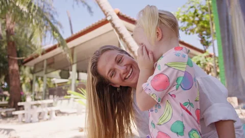 Joyful moments shared between a parent and child at a beachside retreat in sunny Stock Footage 292120194